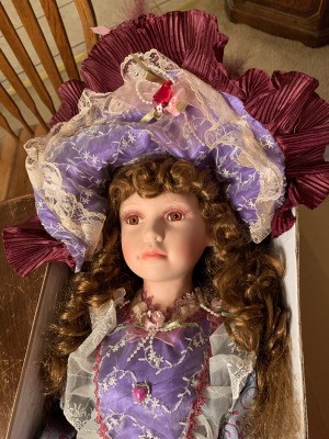 Value of a Cathay Collection Doll - fancy doll wearing a purple lace trimmed dress and matching hat