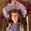 Value of a Cathay Collection Doll - fancy doll wearing a purple lace trimmed dress and matching hat