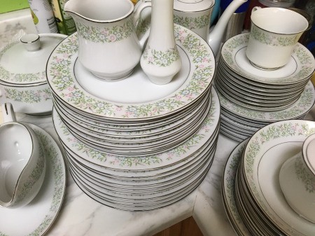 Value of Dinnerware Made in Japan - white dinnerware with a pink, green, and blue floral design around the edge