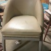 Identifying a Vintage Chair Style - half oval back, vinyl covered armless chair with brass studs across the front