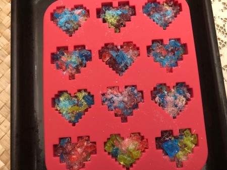 Making Rainbow Lollipops - sprinkle some of each color in the silicone molds