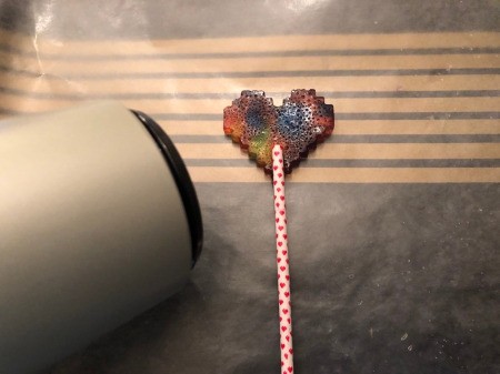 Making Rainbow Lollipops - attach the colored side to stick using high heat on a hair dryer