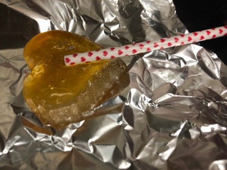 Making Rainbow Lollipops - in a 250F oven you can also attach one side of candy to stick