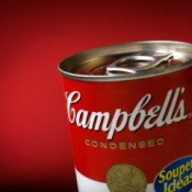 A can of Campbell's soup on a red background.