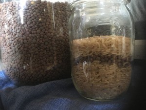 A jar of dried lentils and brown rice.