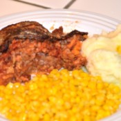 Stuffed Cabbage Casserole on plate with corn & potatoes