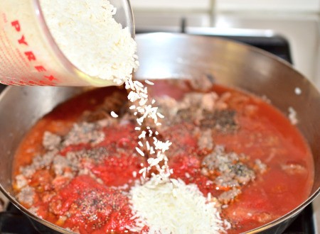 adding rice to pan