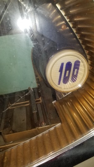 Value of a Seeburg Jukebox - closeup of the emblem with 100 on it