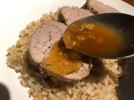 pouring sauce over Pork Tenderloin