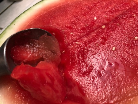 scouping out Watermelon from rind