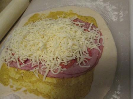 cheese added to meat on dough