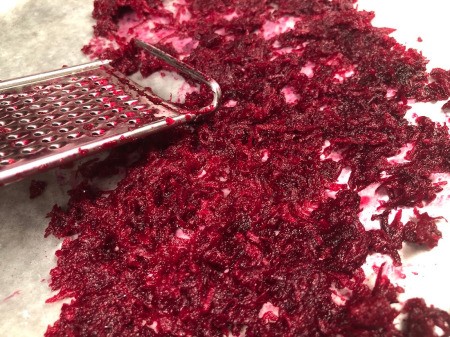DIY Beetroot Powder - line baking sheet with parchment paper and grate beets onto paper