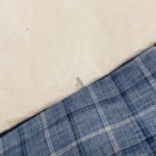 Repairing Clothing Snags - snag isolated against a paper towel