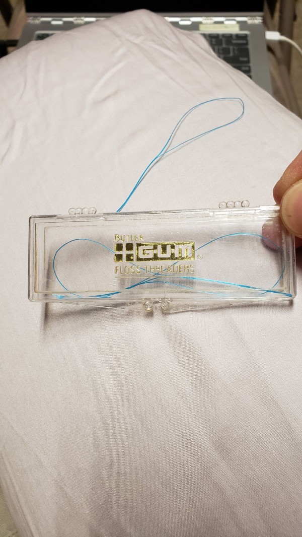 Repairing Clothing Snags - plastic container of floss threaders