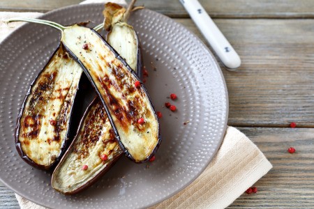 Grilled eggplant halves on a plate