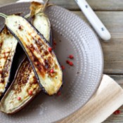 Grilled eggplant halves on a plate