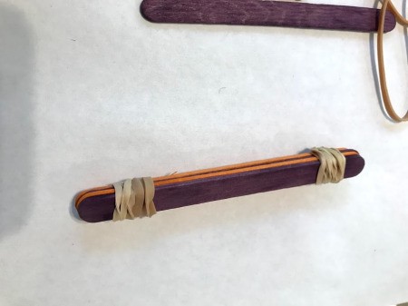 Making a Craft Stick Catapult for Kids - both ends of stack secured