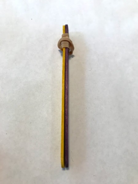 Making a Craft Stick Catapult for Kids - wrap one end of a stack of 2 sticks with a rubber band