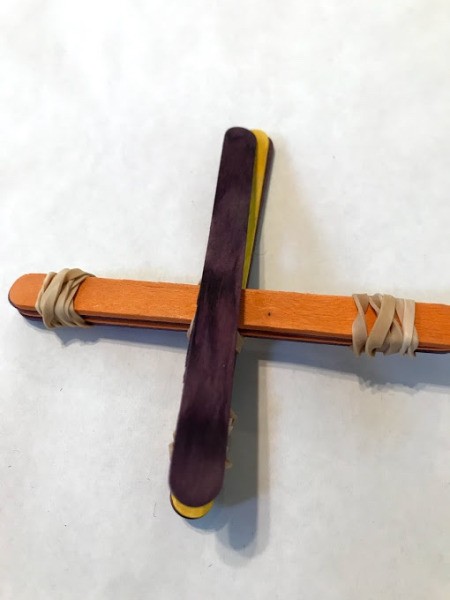 Making a Craft Stick Catapult for Kids - flip over and secure one more stick