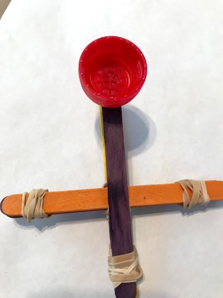 Making a Craft Stick Catapult for Kids - attach bottle cap