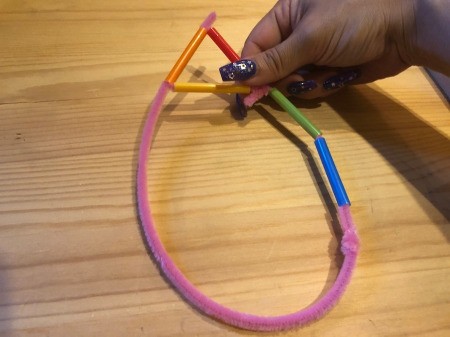 Making Geometric Bubble Wands - thread the end of the pipe cleaner into the top of the triangle
