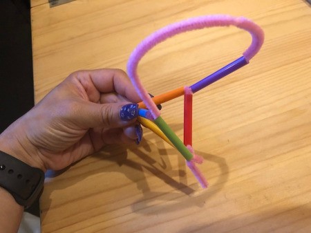Making Geometric Bubble Wands - push the end of the pipe cleaner through the straw so it meets with the overhanging bit