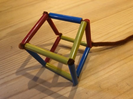 Making Geometric Bubble Wands - push the pipe cleaner through the straw so that it meets the overhanging piece