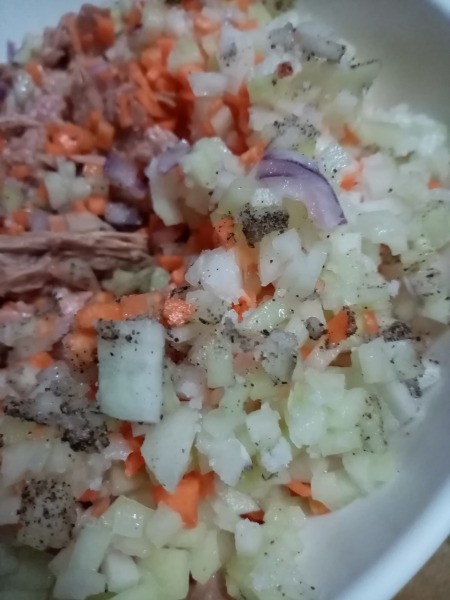 adding seasoning to fish & veggies