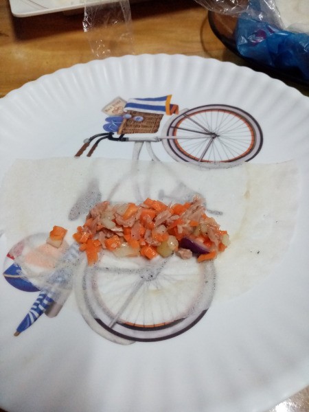 adding fish mix to wrapper