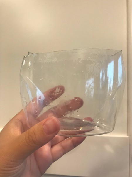 Repupose Mouthwash Container into a Planter - hand holding the portion that will be the planter