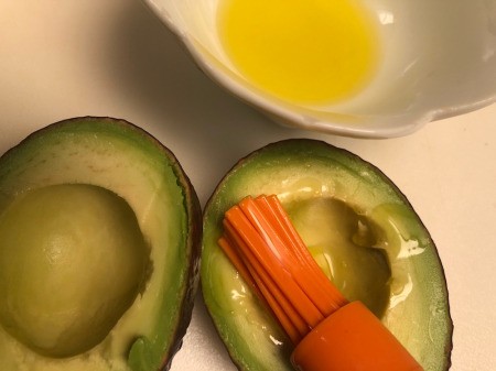 brushing avocado halves with oil