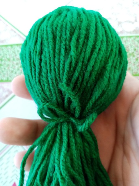 Mr. Octopus Made of Yarn - after covering the paper ball with the yarn tie in place