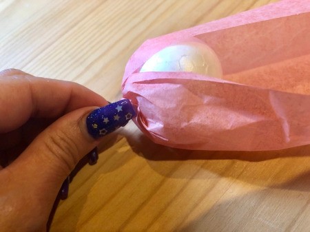 Making Tissue Paper Puffy Flowers - place the ball on one end of the petal paper and twist the end shut