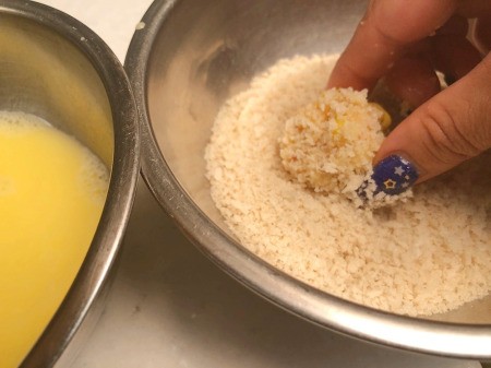 Dipping fritter ball in egg & panko