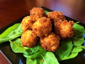 Crispy Grits Fritters on spinach