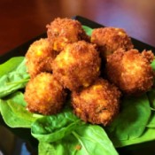 Crispy Grits Fritters on spinach