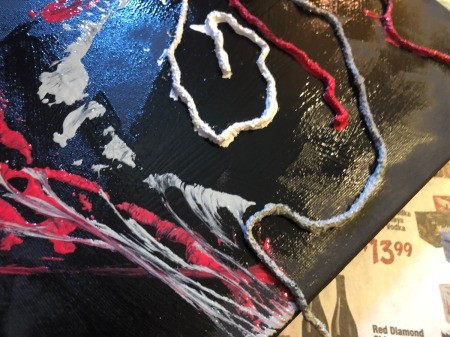 String Pull Abstract Painting - pick up the end of the string and pull down and outward to spread the paint color, mixing and creating a marbleized effect