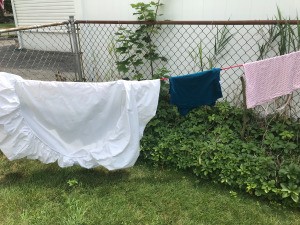 Creative Clotheslines - clothes hanging on a bungy cord between the fence sides