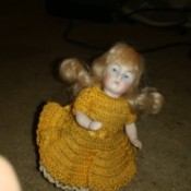 Identifying a Porcelain Doll - small white porcelain doll in gold crochet dress