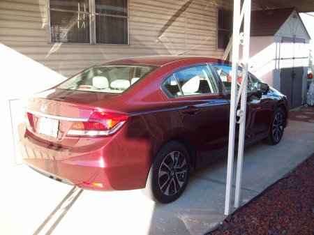 Installing Sunscreen Netting on Aluminum Carport - carport supports and car in background
