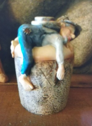 Identifying a Figurine - drunk man lying on belly atop a large jug
