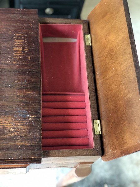 An open drawer of a vintage table.