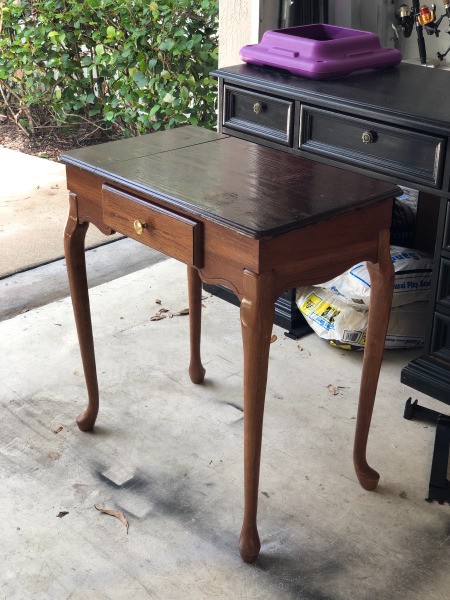 A small vintage table with long legs.