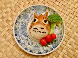 Totoro Inari Sushi Edible Craft - sushi on a plate with a piece of broccoli and three tomatoes