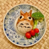 Totoro Inari Sushi Edible Craft - sushi on a plate with a piece of broccoli and three tomatoes