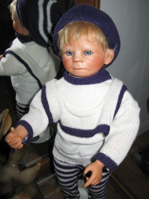 Identifying a Porcelain Doll - boy doll wearing a blue and white sweater and leggings