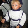 Identifying a Porcelain Doll - boy doll wearing a blue and white sweater and leggings