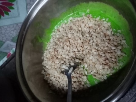 mixing rice puffs with green marshmallow goo