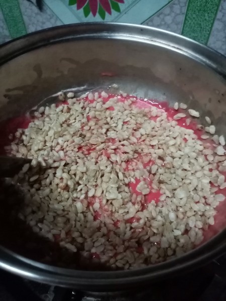 adding puffs to red melted marshmallows