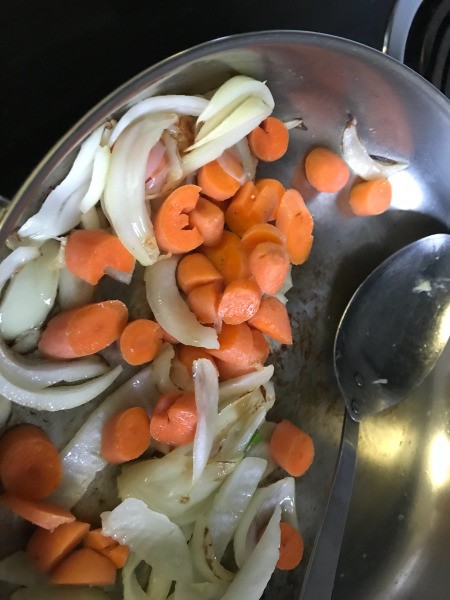 adding carrots to onions